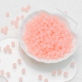 Handmade 6mm pink crystal glass round beads in a white shell-shaped ceramic dish - Peach Chalcedony Beads (6mm)