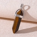Macro shot of a hexagonal Tiger Eye stone pendant with a polished silver metal bail - Tiger's Eye