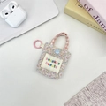 Close-up of floral mini earphone pouch with blue snap button and sozakka label - Colorful Floral