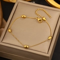 Detailed close-up of golden bean charm bracelet with lobster clasp and adjustable chain - Gold Bean Fine Chain Bracelet (DQY014)