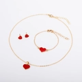 Detailed view of red heart pendant necklace and earring set in polished gold finish - Red