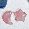 Detail of pink crystal moon and star ornaments on a textured white background - Star and Moon / Rose Quartz Color