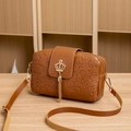 Brown small crossbody bag with crown buckle and tassel featuring embossed patterns - Brown