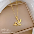 Close-up of golden dove pendant necklace with olive branch and sparkling crystals detail - Gold Bird Holding Flower Style