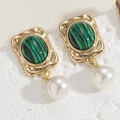 Macro detail of emerald green stone and white pearl earrings with gold metallic base - Malachite Stud Style (ES2330-3)