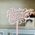 Macro shot of a pink acrylic Happy Valentine cake topper with a glossy artistic font - Pink Happy Valentine's Day