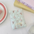Close-up of light green quilted passport holder with cute bear and rabbit cartoon patterns - Salt Style Bunny