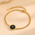 Detail of 18K gold plated stainless steel bracelet with a black faceted stone pendant - Gold Round Black Zirconia (E412)