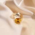 Close-up of golden square ring with white and amber crystals on champagne silk background - Yellow Gemstone Style (WR341-1)