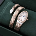 Macro view of a two-tone snake wrap watch with crystal-encrusted dial in a green velvet box - Two-tone Rose Gold Silver White Dial