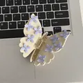 Pince à cheveux papillon crème avec fleurs violettes et strass sur un clavier - Papillon Blanc Cassé