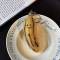 Handmade wool felt banana keychain with smiling face in a ceramic bowl - Lazy Banana