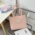 Close-up of pink gingham tote bag with heart quilting on a transparent chair - Blush Pink Plaid