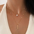 Double-layered gold necklace featuring a clear water-drop pendant on a knit model - Style 12 / Gold