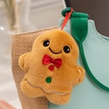 Close-up of a gingerbread man plush pendant with red bow and festive embroidery details - Gingerbread Man