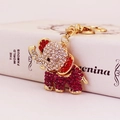 Sparkling gold elephant keychain with vibrant red and clear rhinestones on a pink base - Purplish Red
