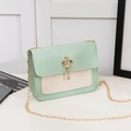Chic mint green and cream crossbody bag with a gold crown pendant and chain strap - Green