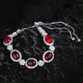 Primer plano de pulsera plateada con cinco rubíes ovales y cordón ajustable de ajuste - Pulsera de circonita roja / Ajustable
