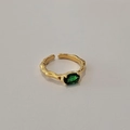 Detail of adjustable gold ring featuring green oval gemstone and irregular hammered texture - Adjustable Open / Gold/Green Zirconia