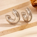 Macro view of chunky silver hoop earrings with clear cubic zirconia trim on stone surface - Hollow Rhinestone Silver C-Shaped Style (F707)