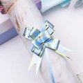 Detailed close-up of a light blue gift bow with gold foil trim for present wrapping - Light Blue Gold Edge