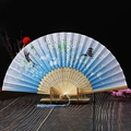 Detail of blue gradient folding fan featuring cherry blossoms, white rabbits and pagoda - Blue Jade Rabbit