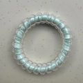Blue spiral telephone cord hair tie with clear TPU outer layer and clover charm detail - Blue Core