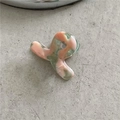 Close-up of small acetate hair claw with pink and green abstract pattern on stone - Green Pink (Mini Cross)