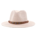 Detail of straw fedora hat featuring a brown band with turquoise beads and brass rivets - Nude Pink