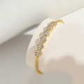 Golden opening bracelet with white zircon flower clusters on a professional white display - Six Flowers (SL0252-3)