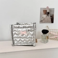 Detailed macro view of silver heart-quilted storage box with a pink lace bow and branding - Heart Silver