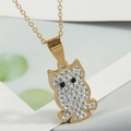 Macro shot of owl pendant necklace with gold plating and shimmering pavé crystals - Gold Owl