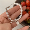 Elegant 925 silver and pearl bracelet with smiley face pendant on a model's hand - Smiley Artificial Pearl Splicing (SL0945)