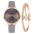 Detailed macro of rose gold watch with moon dial and crystal star charm bracelet - Watch and Bracelet Set / Gray