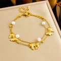Detailed shot of golden double-layer chain bracelet with bow charms and white pearls - Frosted Bow Knot Style(B1647) / Gold