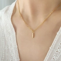 Gold bar pendant necklace with cubic zirconia letter charms on a model - Letter I / Gold