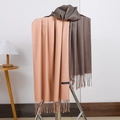 Pink and brown cashmere scarves with elegant tassels displayed on a minimal rack - No.8 Nude Pink
