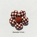 Detail showing a 5.5cm brown checkered flower accessory with soft cotton padding - Off-white Checkerboard