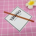 Reusable amber heat-resistant borosilicate glass straw shown on a pink grid background - 8*200mm / Amber Yellow Straight