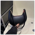 Detail view of black crescent shoulder bag with smooth matte finish and gold hardware - Black