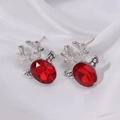 Silver reindeer stud earrings with large red oval gemstone on white satin background - Silver Elk Head 3