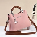 Pink litchi grain leather handbag with brown handles and star pendant charm - Pink