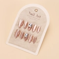 Macro detail of almond-shaped cat-eye press-on nails with rhinestones and pearl accents - By1731 / Glue Type