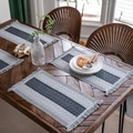 Striped gray woven placemat with fringed edges on dark wood table setting - Center Gray