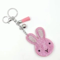 Pink velvet rabbit keychain with rhinestones, leather tassel and a silver bell charm - Pink