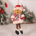 Close-up of a plush Christmas bear ornament with red plaid details hanging on a tree - Bear Style