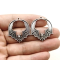 Detail of vintage bat pendants in antique silver finish held for scale on white background - Antique Silver