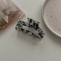Detail shot of a large rectangular acetate hair claw with black and white ink pattern - Medium Square Claw / Black and White Leopard Print