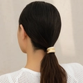 Detail of gold hammered metal elastic hair tie worn on a ponytail for a modern look - Gold Hammered (0564)