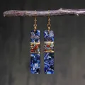 Detail of bohemian drop earrings with blue stone texture and gold wire wrapped beads - Dark Blue Marble Long Rectangular Style (ER1002)